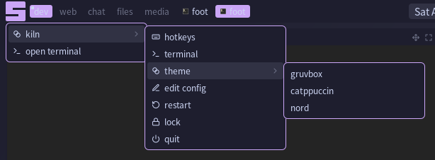 The main menu open under the launcher glyph, with the kiln submenu and the theme submenu open beside it